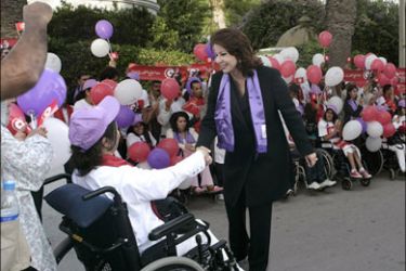 afp - Tunisian President Zine El Abidine Ben Ali's wife Leila (R) shakes hands with a young disabled supporter during a campagne meeting in Tunis on October 22, 2009