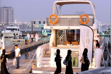 Visitors walk along the jetty looking at boats and yachts during an exhibition sponsored by the Dubai World Trade Centre in the Saudi city of Jeddah, on October 16, 2009