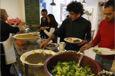 Lebanese people fill their plates at a self-service organic food restaurant in Beirut on December 5, 2009.
