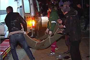REUTERS/ Image from a video grab shows paramedics carrying a stretcher with an injured person towards an ambulance in Perm December 5, 2009. At least 94 people were killed and
