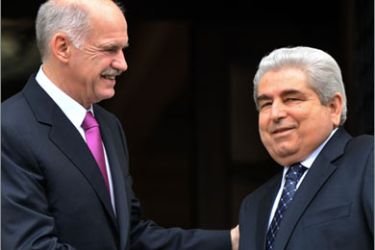 Greek Prime Minister George Papandreou (L) welcomes Cypriot President Dimitris Christofias in Athens on January 18, 2010. Cypriot President is in Greece on a four-days visit for talks focusing
