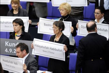 afp : Parliamentarians of the Left party (Die Linke) hold up placads featuring the names of victims of a bombing in Kundus, ordered by the German armed forces last
