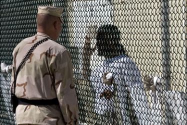 afp : (FILES)This April 24, 2007 file photo shows a Joint Task Force guard (L) at Camp #1 inside the detainee center at Camp Delta in Guantanamo Bay Naval Station, Cuba, as he