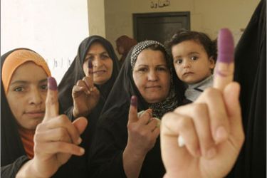 Iraqi women show their ink-stained fingers after casting their votes at a polling station in Baquba, northeast of Baghdad, on March 7, 2010