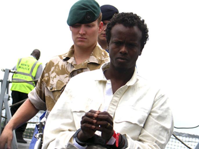 British Navy officials escort a suspected Somali pirate from the ship HMS Lancaster F 229 at the Kenyan Port City of Mombasa