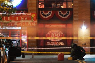 A New York Police Department bomb squad member investigates a gasoline can that was in a suspicious vehicle (L, door open) early Friday, May 14, 2010 near Union