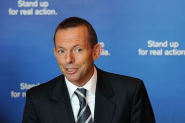Opposition Liberal Party leader Tony Abbott stands in front of the party's slogan in a press conference while campaigning in Melbourne on July 19, 2010.
