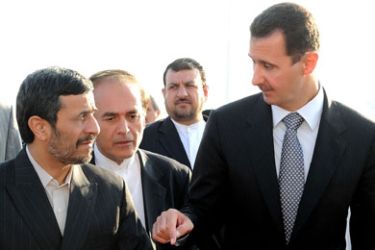 A handout picture released by the official Syrian Arab News Agency (SANA) shows Syria's President Bashar al-Assad (L) welcoming his Iranian counterpart Mahmoud Ahmadinejad at Damascus airport on September 18, 2010