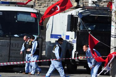 Investigators investigate the area where a suicide bomber blew himself up in the centre of Istanbul on October 31, 2010
