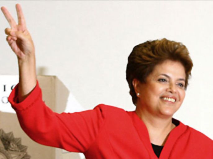f_Dilma Rousseff, presidential candidate for the ruling Workers Party (PT) flashes the "v" sign after voting at a polling station in Porto Alegre, state of Rio Grande do Sul, Brazil, on October