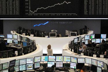 r_Traders are pictured at their desks in front of the DAX board at the Frankfurt stock exchange November 15, 2010. REUTERS/Remote/Kirill Iordansky