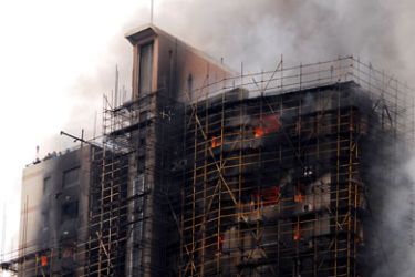 CHINA : This photo taken on November 15, 2010 shows a huge fire engulfing a high-rise in Shanghai, after construction scaffolding surrounding the building initially caught fire, spreading to the building itself. The accident left at least five people dead, sending billo