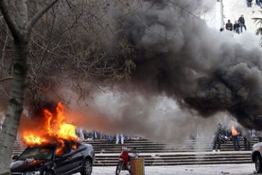 Two cars are set on fire during riots on Friday between supporters of Albania's opposition Socialist Party and police in front of the government building in Tirana January 21, 2011. The opposition had called the rally to demand fresh elections and the government's resignation over corruption allegations.