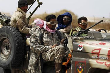 r_Rebels retreat after forces loyal to Muammar Gaddafi attacked them near Brega in eastern Libya, March 30, 2011. REUTERS/