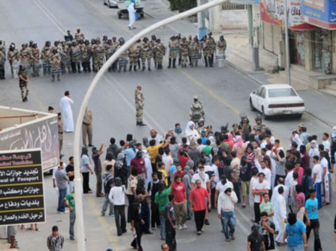 Anti-riot police face off with protesters in Saudi Arabia's eastern Gulf coast town of Qatif March 11, 2011. Police flooded the streets of the Saudi capital on Friday to deter a planned day of protests inspired by pan-Arab revolt, but a small Shi'ite demonstration was reported in the country's oil-producing east.