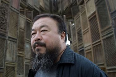 KASSEL, GERMANY - JUNE 13 Chinese Artist Ai Weiwei poses in front of his sculpture 'Template' during a media preview of Documenta 12 on June 13, 2007 in Kassel, Germany