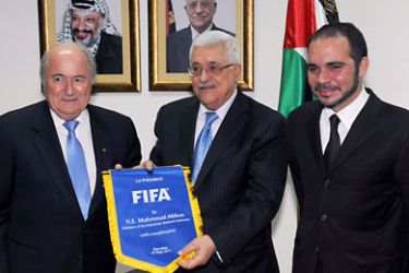 getty-Palestinian President Mahmoud Abbas (C) receives a FIFA pennant from FIFA President Sepp Blatter (
