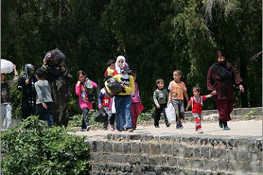 Hundreds of Syrians, most of them women and children, fearing fresh violence as a result of anti-regime protests in their country cross the illegal Buqaya border point from Tall Kalakh into northern Lebanon's Wadi Khaled area on May 14, 2011 as witnesses in tall Kalakh said Syrian