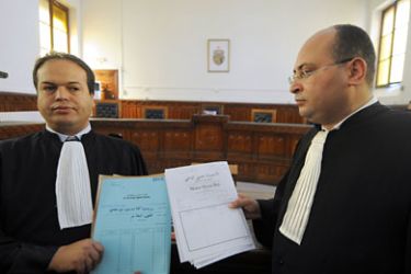 Bechir Mahfoudhi (L) and Hosni Beji, lawyers appointed to defend Tunisia's deposed President Zine El Abidine Ben Ali stand in court in Tunis on June 30, 2011 after striking judges postponed a second trial of Ben Ali until July 4,
