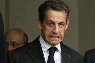 r_France's President Nicolas Sarkozy reacts as he accompanies a guest after a meeting at the Elysee Palace in Paris July 27, 2011.