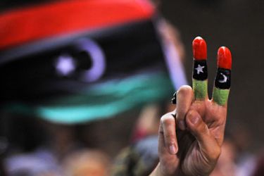 AFP- woman with fingers painted in the colours of the Libyan flag celebrates in Martyrs Square (formerly Green Square under Kadhafi) in Tripoli