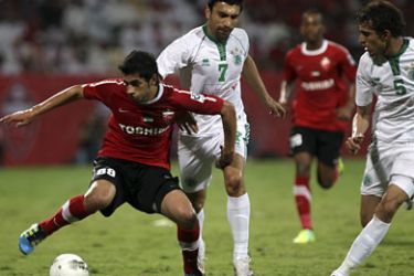 r_Majed Hasan Ahmad (L) of UAE's Al Ahli fights for the ball with Walid Yousef (R) and Aziz Haydarove (C) of UAE's Al Shabab during their GCC Champions League final soccer