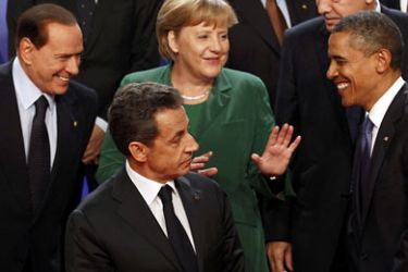 r_Italy's Prime Minister Silvio Berlusconi, France's President Nicolas Sarkozy, Germany's Chancellor Angela Merkel and U.S. President Barack Obama (L to R) discuss as they take part in the traditional family photo during the G20 Summit of major world economies in Cannes November 3, 2011