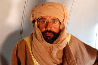 Saif al-Islam Gaddafi is seen sitting in a plane in Zintan November 19, 2011. Saif al-Islam Gaddafi told Reuters on Saturday that he was feeling fine after being captured by some of the fighters who overthrew his father and he said injuries to his right hand were suffered during a NATO air strike a month ago.