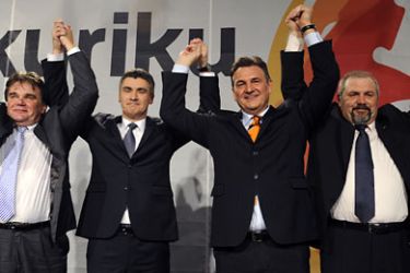Croatia’s main opposition leader Zoran Milanovic (2L) and his coalition partners Ivan Jakovcic (L), Radimir Cacic (2R) and Silvano Hrelja (R) reaise their hands after hearing preliminary results of Croatian parliamentary elections in Zagreb, on December 4, 2011. Croatia's centre-left opposition bloc won Sunday's general elections by a wide margin, according to partial official results based on more than 50 percent of votes counted nationwide ousting the corruption-plagued ruling conservatives.