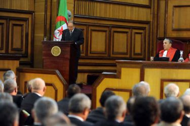 Algerian President Abdelaziz Bouteflika (L) speaks as Algerian Justice minister Tayeb Belaiz (R) sits during a ceremony marking the official opening of the 2011-2012