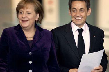 German Chancellor Angela Merkel and French President Nicolas Sarkozy arrive for a press conference following a meeting at the Chancellery in Berlin on January 9, 2012. Nicolas Sarkozy called for a new European pact enforcing tighter budgetary discipline to be signed by member states on March 1. AFP PHOTO / ODD ANDERSEN