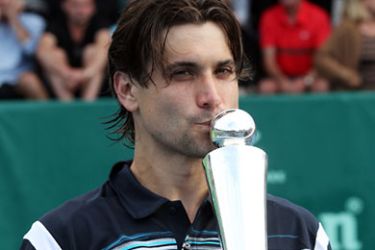 David Ferrer of Spain celebrates with the trophy after beating Olivier Rochus of Belgium during their men's singles final match at the Heineken Open tennis tournament in Auckland on January 14, 2011. AFP PHOTO / Michael BRADLEY