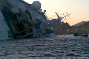 The Costa Concordia is pictured on January 14, 2012, after the cruise ship ran aground and keeled over off the Isola del Giglio, last night. Three people died and about 70 were missing on January 14 after an Italian cruise ship with more than 4,000 people on board ran aground and keeled over, sparking scenes of panic.The Costa Concordia was on a trip around the Mediterranean when it apparently hit a reef near the island of Giglio on Friday, only a few hours into its voyage, as passengers were si