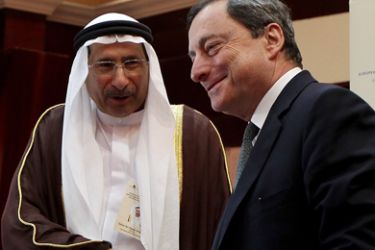 European Central Bank chief Mario Draghi (R) shakes hands with UAE Centeral Bank Governer Sultan bin Nasser al-Suwaidi following thier joint press conference in Abu Dhabi on January 19, 2012. Draghi said he was confident the European Union common curreny will perform better this year.