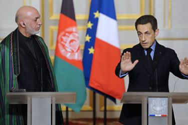Afghan's president Hamid Karzai (L) listens to France's President Nicolas Sarkozy (R) speaking during a press conference with his at the presidential Elysee palace on January 27, 2012 in Paris. Karzai met Sarkozy a week after the French leader threatened to pull his troops out of Afghanistan. AFP PHOTO