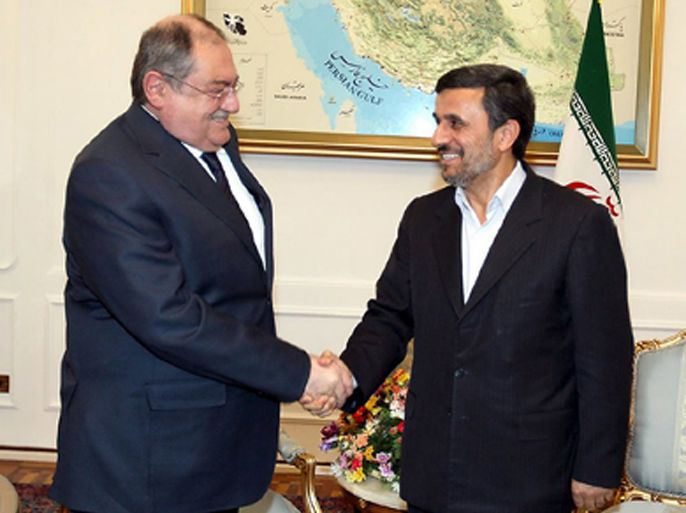 A handout picture released by the Iranian presidency shows Iranian President Mahmoud Ahmadinejad (R) shaking hands with Lebanese Defence Minister Fayez Ghosn during a meeting in Tehran on February 26, 2012.