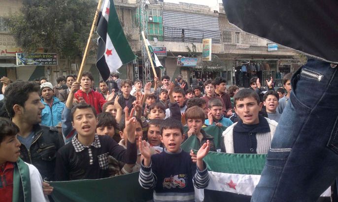 Youths take part in a demonstration against Syria's President Bashar Al-Assad in Kafranbel near Idlib February 28, 2012. Picture taken February 28, 2012. REUTERS/Handout (SYRIA - Tags: CIVIL UNREST POLITICS) FOR EDITORIAL USE ONLY. NOT FOR SALE FOR MARKETING OR ADVERTISING CAMPAIGNS. THIS IMAGE HAS BEEN SUPPLIED BY A THIRD PARTY. IT IS DISTRIBUTED, EXACTLY AS RECEIVED BY REUTERS, AS A SERVICE TO CLIENTS