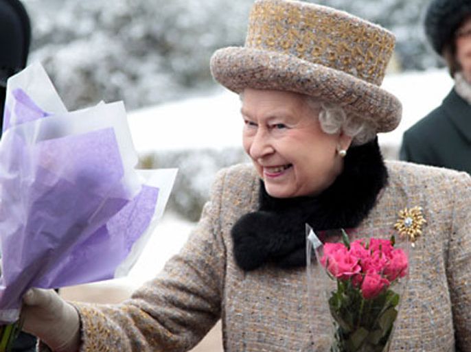 Queen Elizabeth II smiles as she receives flowers after the Sunday Service at West Newton Church on February 5, 2012 in West Newton. Queen Elizabeth II and her husband Prince Philip braved the snow for a village church service on Sunday, the eve of the Diamond Jubilee marking 60 years of Elizabeth's reign. AFP PHOTO/POOL/ Chris Jackson