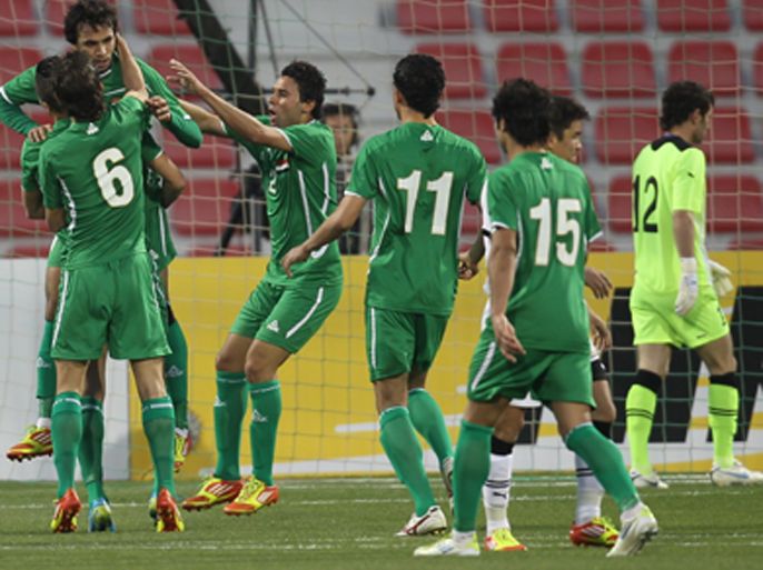 Iraq's soccer team players celebrate after beating Uzbekistan during their third Asian qualifying match for the 2012 London Olympic Games at the Al-Arabi stadium in the Qatari capital Doha on February 21, 2012. Iraq won match 2-1.