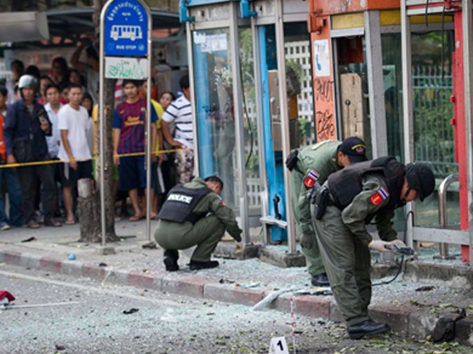 Thai bomb squad officials inspect the site of an explosion in Bangkok on February 14, 2012. Three minor blasts rattled the Thai capital Bangkok, leaving a foreigner seriously wounded when a grenade he was suspected of carrying exploded, police said.