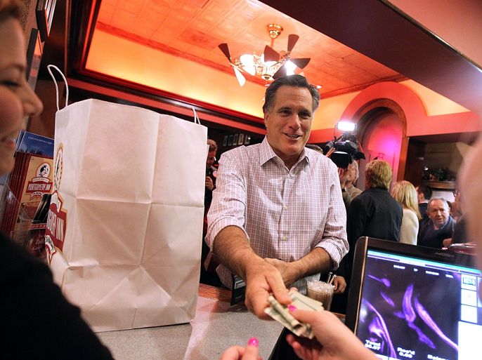 CINCINNATI, OH - MARCH 03: Republican presidential candidate, former Massachusetts Gov. Mitt Romney pays for a to-go food order at The Montgomery Inn Restaurant at the Roadhouse on March 3, 2012 in Cincinnati, Ohio. Mitt Romney is campaigning in Ohio ahead of Super Tuesday.