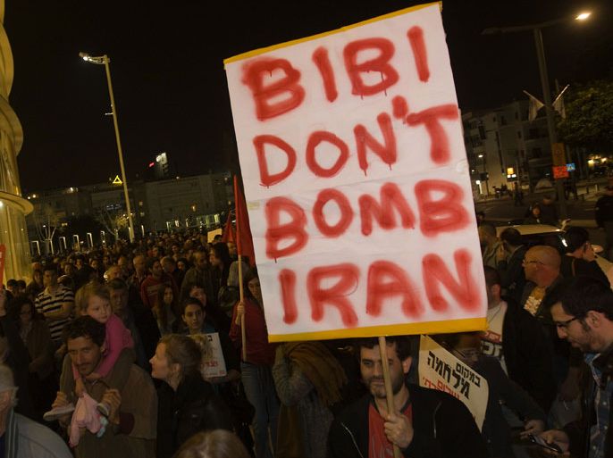 An Israeli anti-war protester holds a sign asking Prime Minister Benjamin Netanyahu not to bomb Iran during a demonstration in Tel Aviv on March 24, 2012