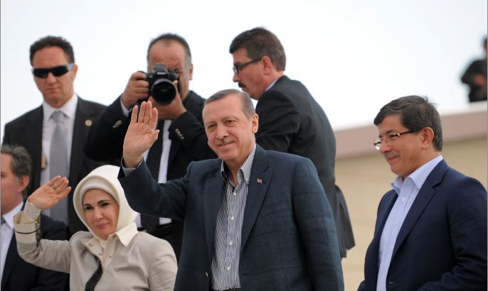 Turkish Prime Minister Recep Tayyip Erdogan (C) waves  after delivering a speech to Syrian refugees as Foreign Minister Ahmet Davutoglu (R) him on May 6, 2012 at the Oncupinar Refugee Camp in Kilis.   Turkish Prime Minister Recep Tayyip Erdogan met for the first time with Syrian refugees, speaking to them near the border town of Kilis, southeastern Turkey.