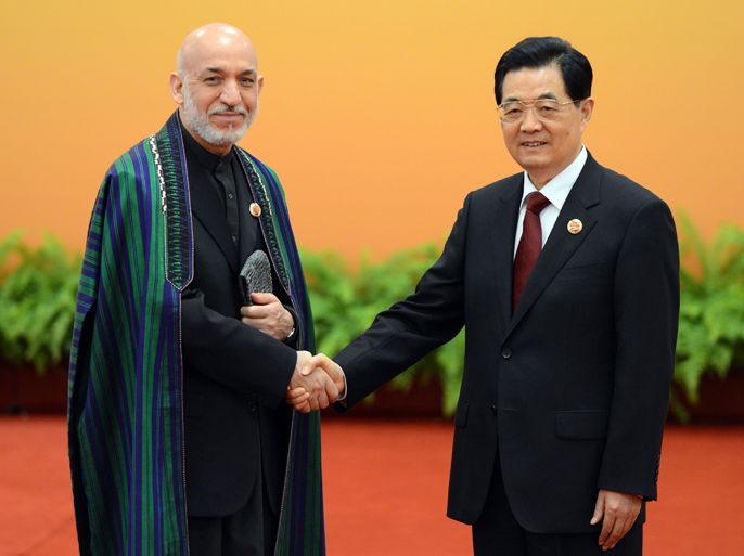 Chinese President Hu Jintao (R) greets Afghanistan President Hamid Karzai at the Shanghai Cooperation Organization (SCO) summit in the Great Hall of the People in Beijing on June 7, 2012. Security in Central Asia, including the situation in Afghanistan, is set to be the focus of talks at a meeting in Beijing of a regional group dominated by China and Russia. AFP