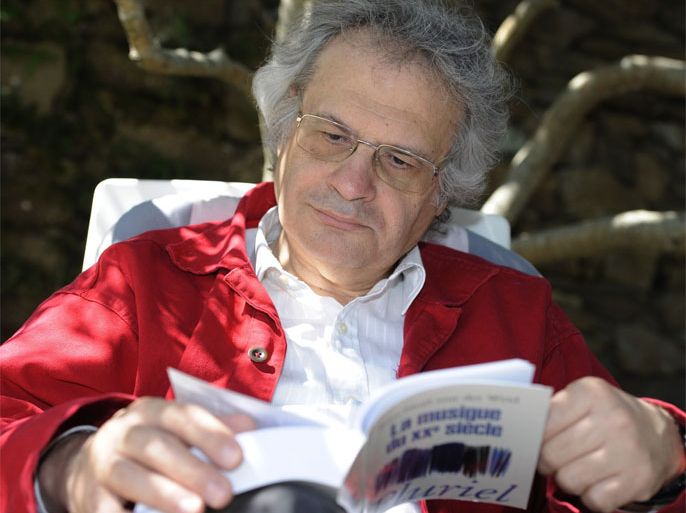 French-Lebanese writer Amin Maalouf looks at a book, on July 18, 2011, in the garden of his home at the Cadouere hamlet in Yeu island, western France. Maalouf, 62, whose books seek to build bridges between East and West, will succeed to French anthropologist Claude Levi-Strauss at the French Academy (official authority on the French language). Maalouf has published several novels that focus on the themes of Arab religious and national identity, in addition to journalism, essays and a work of history.