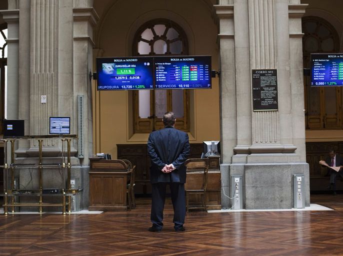 A trader looks at electronic boards at Madrid's stock exchange June 29, 2012. The euro jumped nearly 2 percent, oil prices soared and world stocks rallied on Friday after euro zone leaders agreed on measures to cut soaring borrowing costs in Italy and Spain, in addition to directly recapitalizing regional banks. REUTERS/Susana Vera (SPAIN - Tags: BUSINESS)