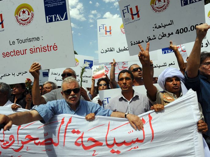 FB1685 - Tunis, -, TUNISIA : Tunisian employees of the tourism industry shout slogans during a demostration to defend the sector on June 16, 2012 in Tunis. Around 200 hoteliers, employees of travel agencies and tour operators have responded to the call of the Tunisian tourism industry associations to demand a strong response to the violence of the authorities earlier this week. AFP PHOTO / KHALIL