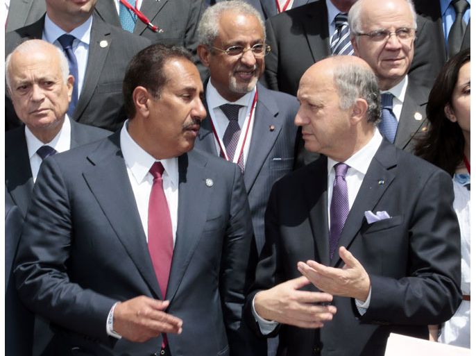 French Foreign Minister Laurent Fabius (R) speaks with Cheikh Hamad bin Jassem Al-Thani from Qatar (L) following a meeting of the "Friends of the Syrian People" with all his counterparts at the MFA Conference Center in Paris on July 6, 2012