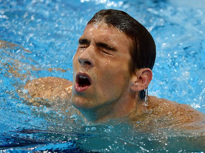 US swimmer Michael Phelps takes a breath after competing in the men's 400m individual medley heats swimming event at the London 2012 Olympic Games on July 28, 2012 in London. AFP PHOTO / EMMANUEL DUNAND