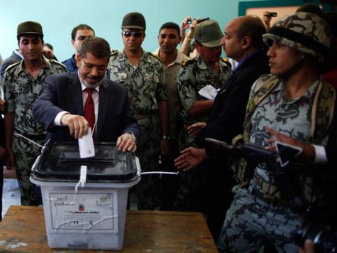 Presidential candidate Mohamed Morsy of the Muslim Brotherhood casts his vote in a polling station in a school in Al-Sharqya, 60 km (37 miles) northeast of Cairo June 16, 2012. Egypt's first free presidential election concludes this weekend in a run-off between the Muslim Brotherhood's candidate Mohamed Morsy and Ahmed Shafik, the last prime minister of ousted leader Hosni Mubarak. REUTERS